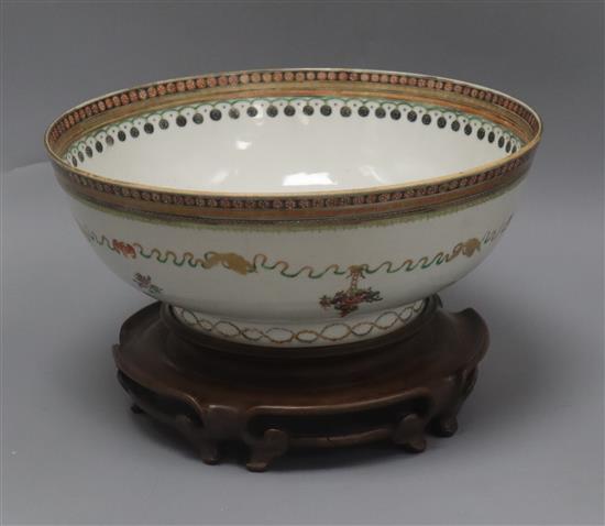 A late 18th century Chinese export polychrome bowl, decorated with a band of ribbon and flowers in baskets, with hardwood stand diamete